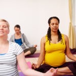 Pregnant women in yoga meditation class